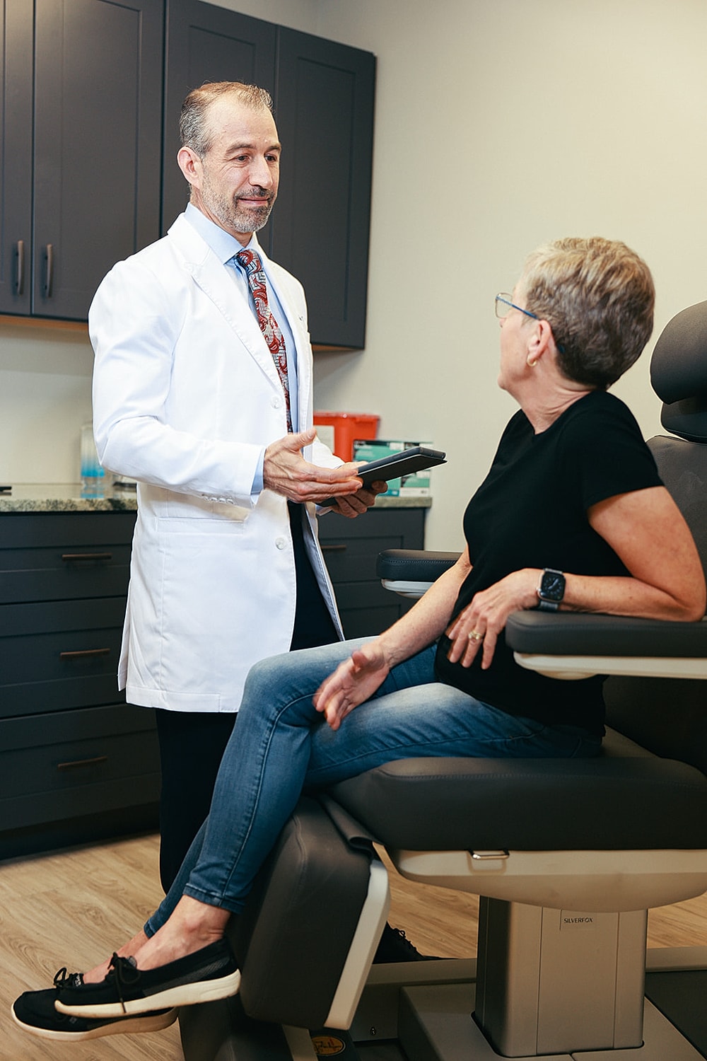 Doctor consulting with patient in medical office.