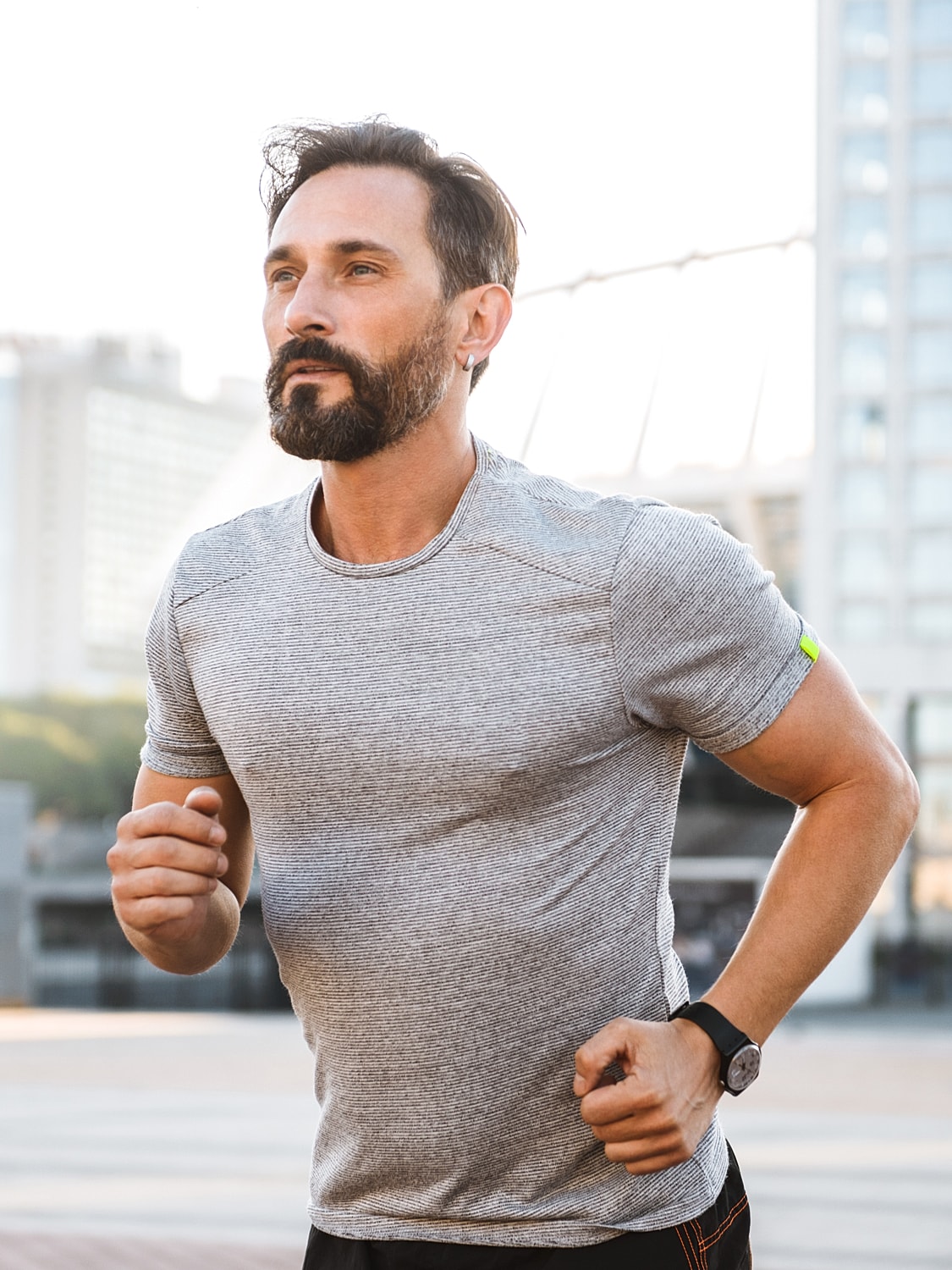 Man jogging in urban setting during daytime.