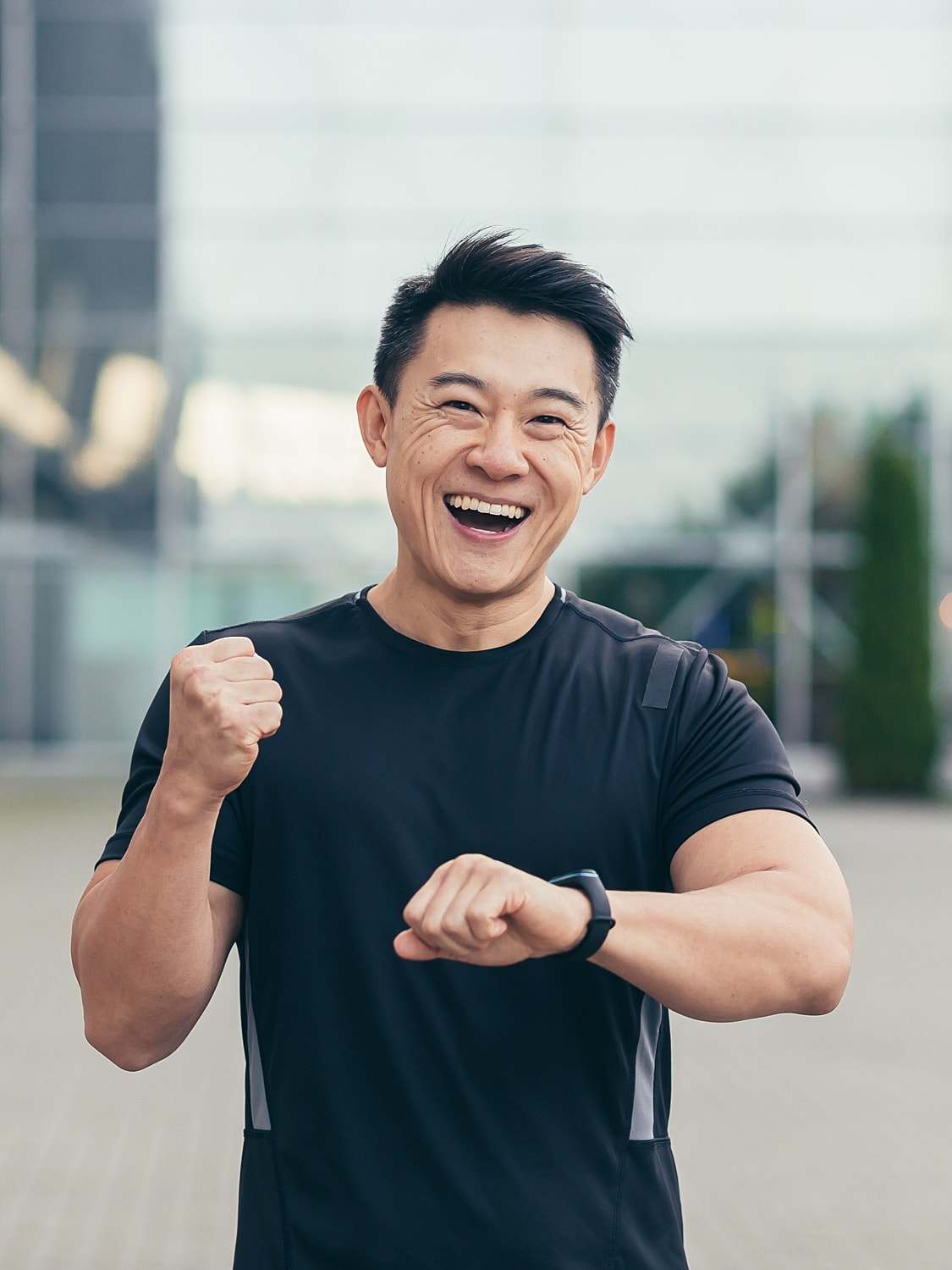 Man leaning against rock, outdoors, looking upward.