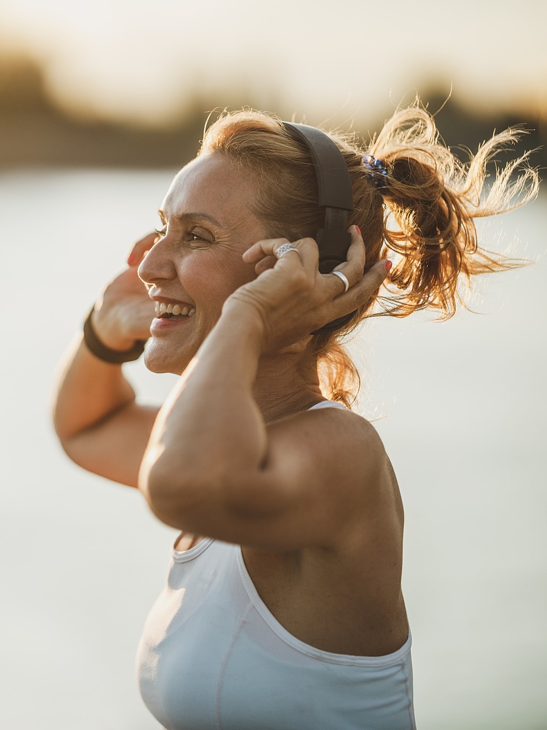 Person running in athletic gear with earbuds.