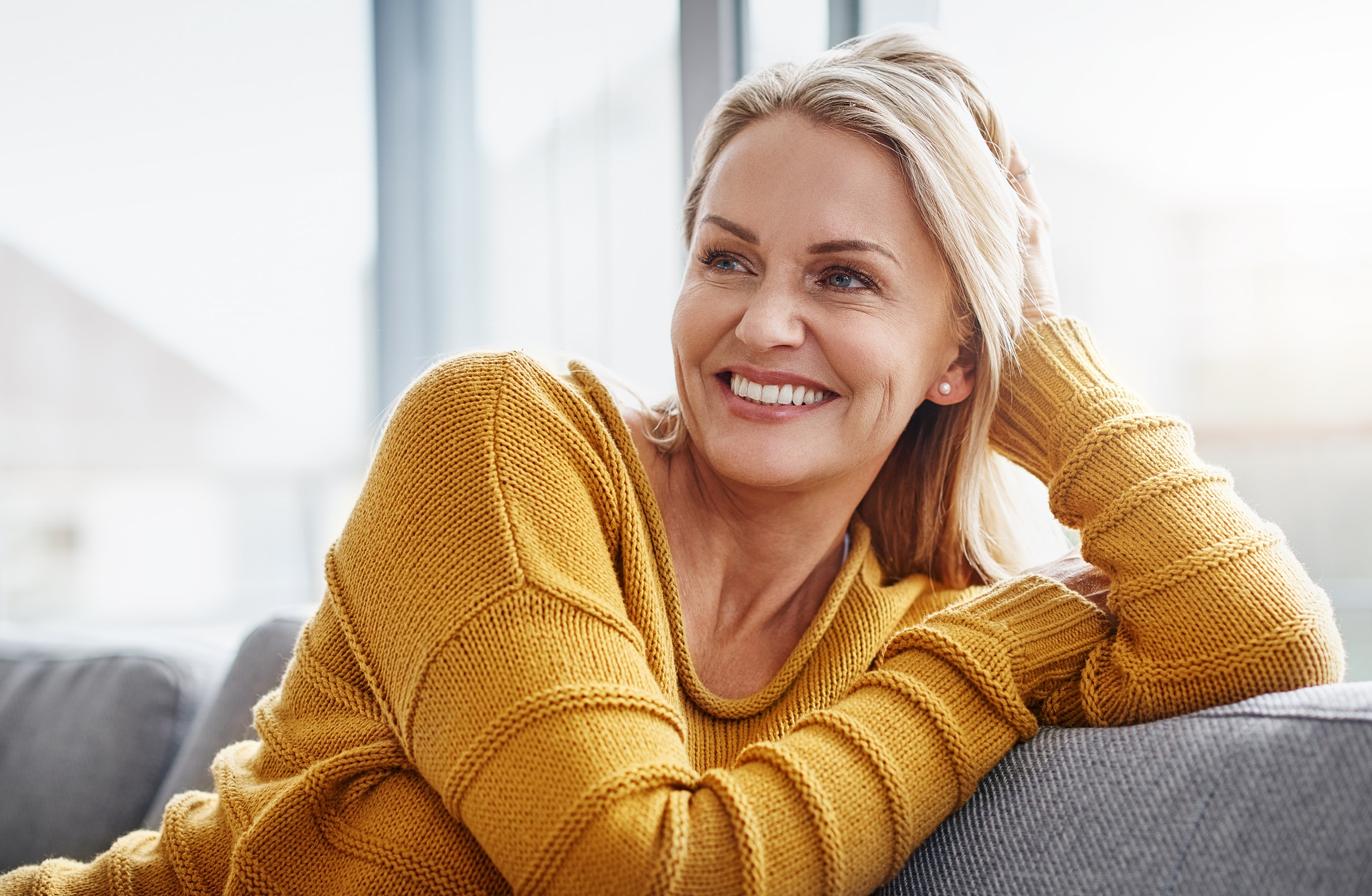 Smiling woman in a natural outdoor setting.