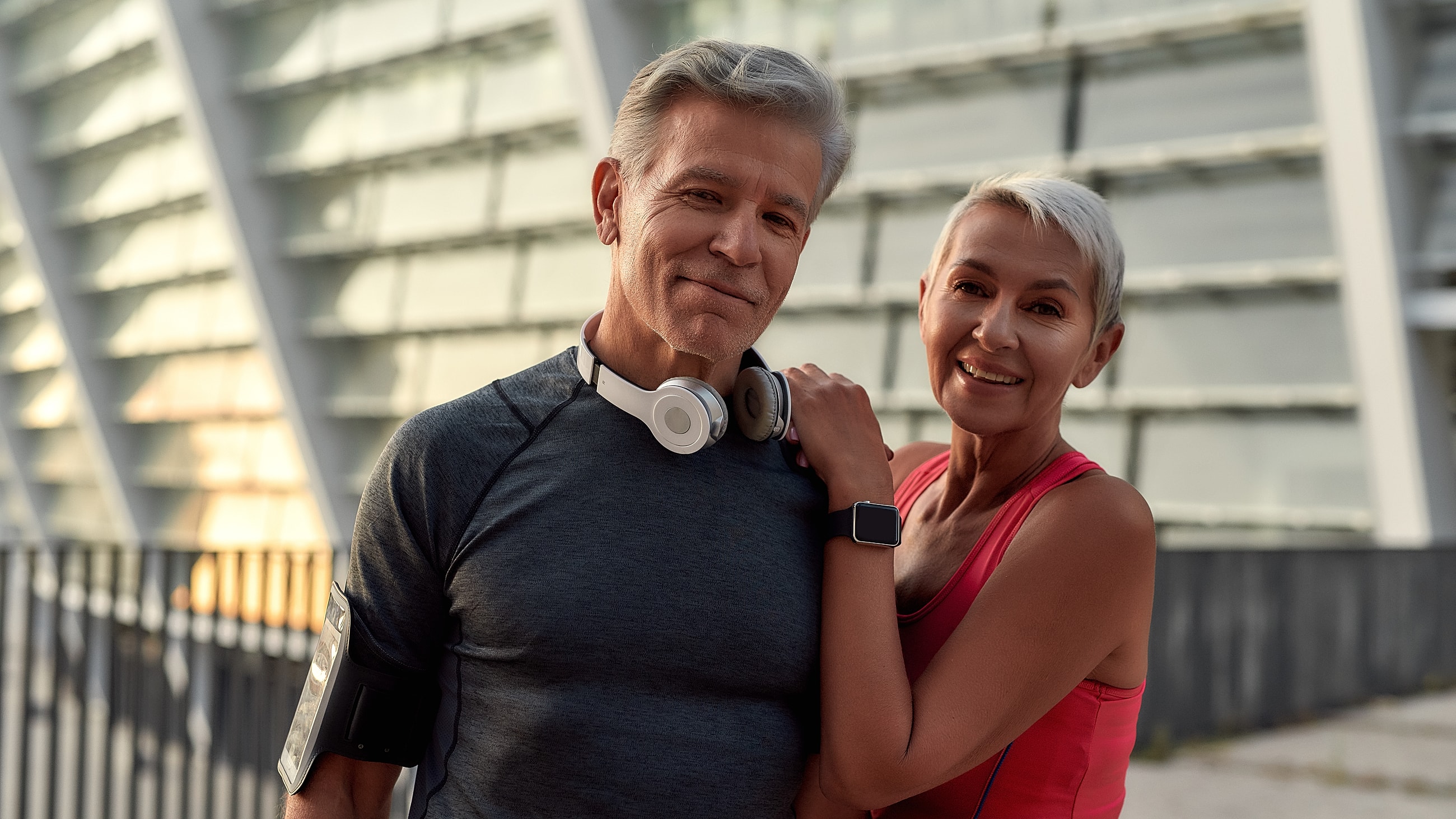 Couple enjoying outdoor fitness together, smiling.